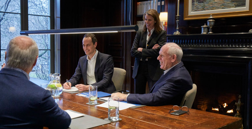 Kate Pal, Joe Pal, and Patrick Kavanagh advising a client at boardroom table