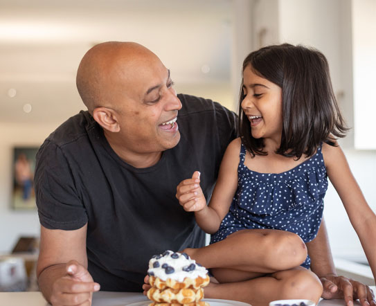 Wealthy father and daughter at home with waffles